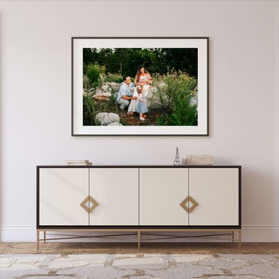 Springfield Mo newborn photography of framed photo of afamily holding newborn playing with toddler