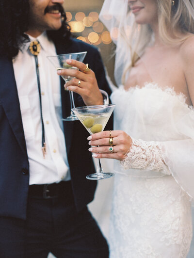 Bride & Groom holding hands in front of hilly landscape