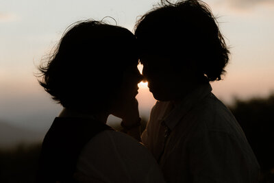 bride and groom embrace in grand teton national park in wyoming at golden hour