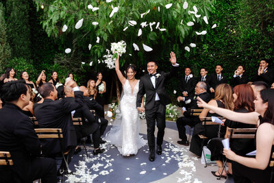 Bride and Groom walking up ceremony aisle at the Fig House Los Angeles