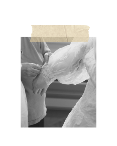 Hands buttoning the sleeve of a wedding dress, representing the moments clients cherish when they work with Birdie June for events and planning their wedding.