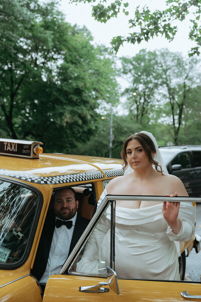 bride and groom posing with taxi after eloping shot by Elsie Goodman Photography | NYC Elopement Packages
