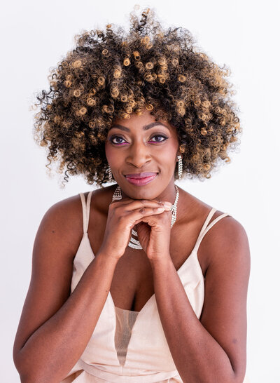 beautiful headshot of woman with hands by face
