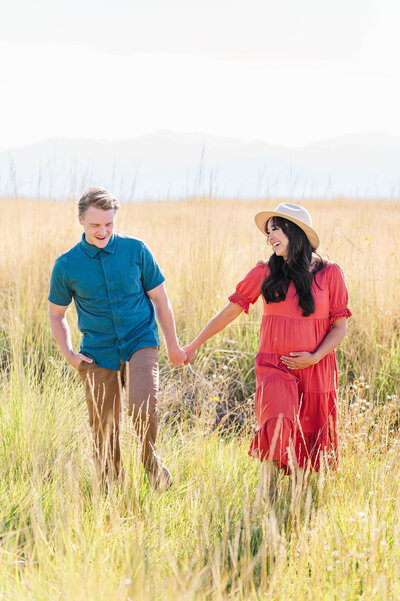 Best newborn photographer in Franklin, Massachusetts shot of pregnant woman and man holding hands