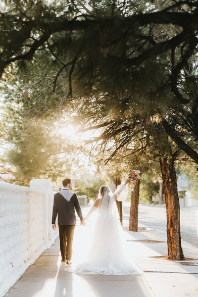 Bride and groom walking away from the camera