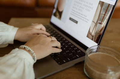 Larks Atelier founder Brittany Fitch, working on a custom web design for a high-end photographer.