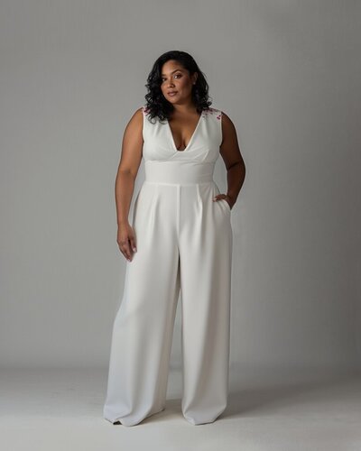 Chic bridal jumpsuit in crepe with 3D flower details.