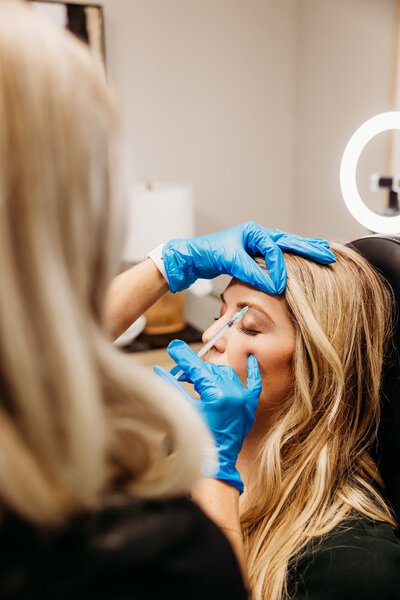 Woman receiving a Botox injection at vIVid