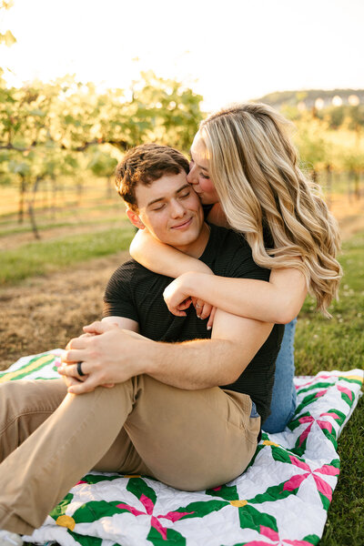 Couple posing on a picnic blanket during Nashville engagement session