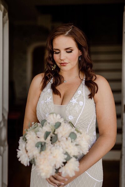 Bride with romantic soft glam makeup — warm tones, glowing highlights, and long lashes styled by Klover Beauty for a Maryland wedding.