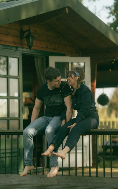 A couple sitting on the porch, sharing a peaceful and intimate moment