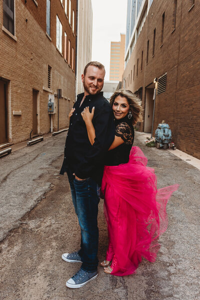 Kimberly, a realtor at Capital Realty, posing confidently in a professional portrait with her husband