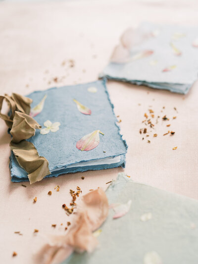 A trio of pressed flower booklets with raw silk ribbon