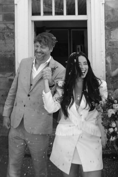 Wedding photographer captures couple taking a stroll hand in hand at their french chateau wedding.