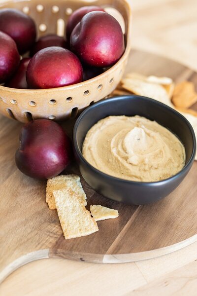 Plums, chips, and hummus kitchen display by interior designer, Natalie Barnas in San Diego, California.