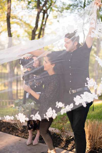 videographers capturing bride's veil