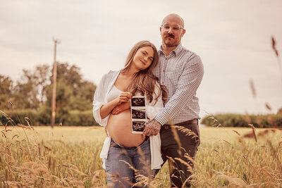 young-son-kissing-mothers-baby-bump