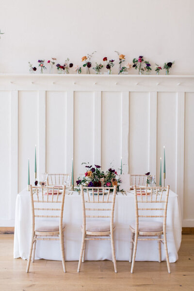 white sample table with chairs and flowers in millbridge court