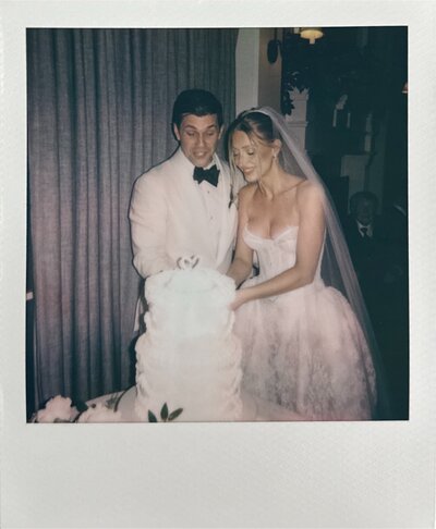 a polaroid of a bride and groom cutting their wedding cake