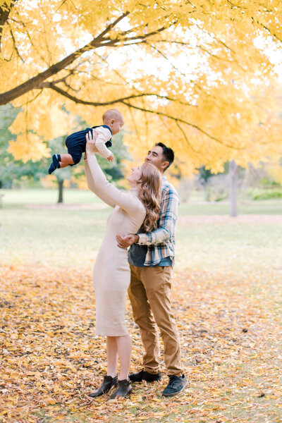 parents holding up son at finch arboretum by one of the best spokane photographers