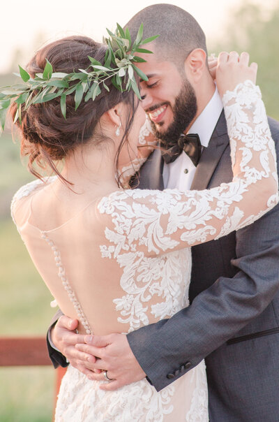 a groom embraces his bride at the hanford ranch winery in galt, ca