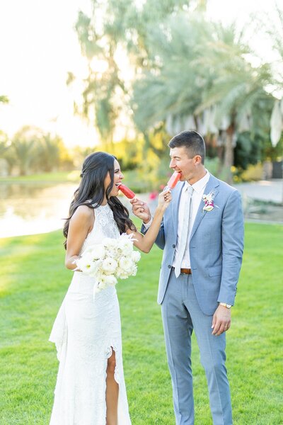 Bride and groom eating Palm Springs Paletas at Old Polo Estate in Coachella, California - Sherr Weddings