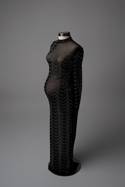 Mesh overlay gown with geometric webbing on a black mannequin

