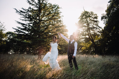 A newly married couple dancing in a wodded area at sunset taken by London Wedding Photographer Liberty Pearl