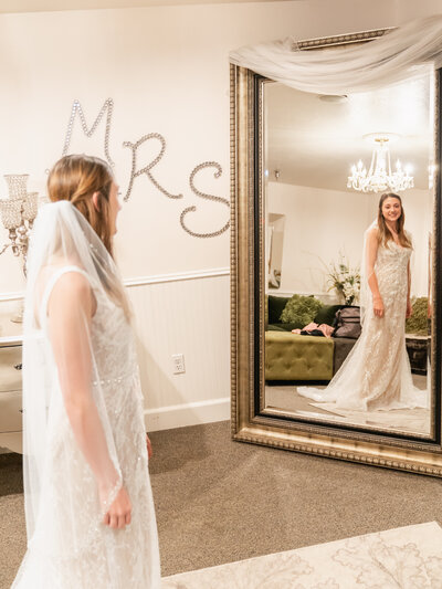 Captivating image of a bride in her wedding dress, capturing her reflection in the mirror as she prepares for her special day, embodying grace and beauty.