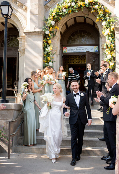 Bride and groom in black tux and simple wedding gown walking hand in hand taken by wedding photographer chicago Allison Francois
