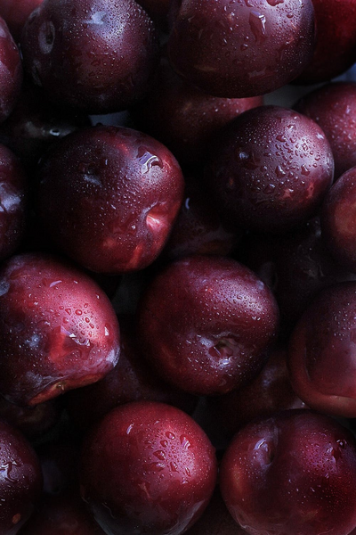 Close-up of glistening red cherries with droplets of water