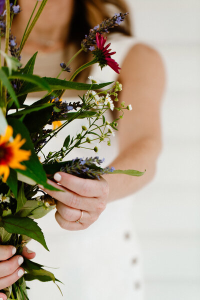 Sam holding wildflowers