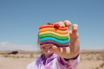 Girl holding a pride cookie.