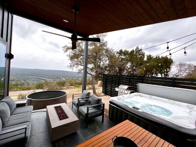 Outdoor space with grey chairs and hot tub