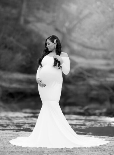 Fitted long-sleeve gown with mermaid train, photographed in black-and-white in studio