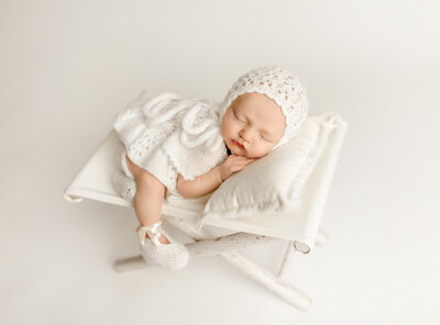 Newborn portrait captured with emotional, gentle lighting and serene fine-art styling in a luxury Guelph studio.