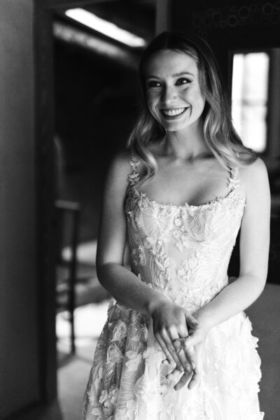 Black and white photo of bride smiling