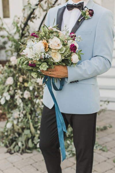 Wedding Photographer & Elopement Photographer, groom holding bride's bouquet