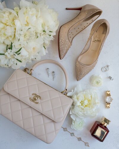 Flat lay of neutral wedding shoes and other luxury details
