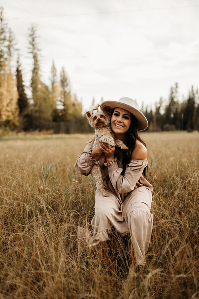 photographer sitting in fields with dog