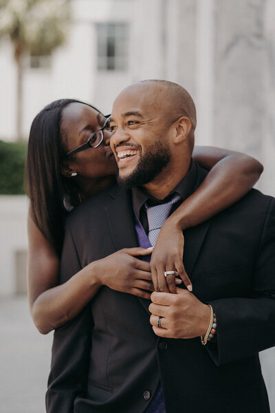 couple laughing on wedding day holding hands