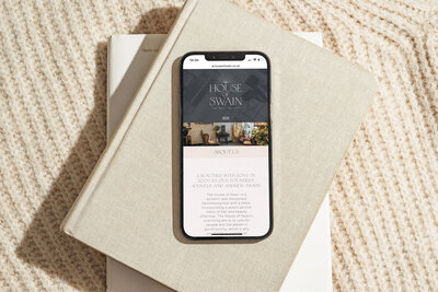 House of Swain iPhone mock up on book stack