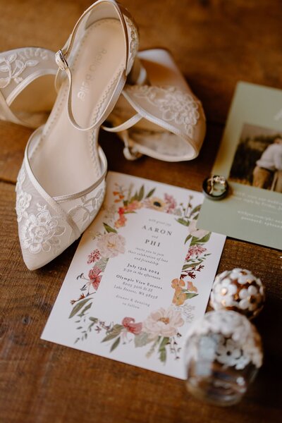 Top view of wedding stationery with brides shoes and perfume bottle