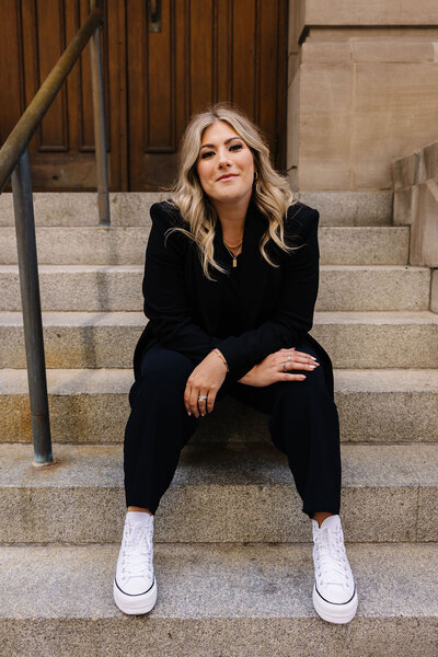 Calgary Realtor Leigh Kormos sitting on the front steps