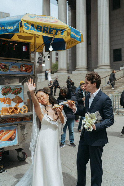 bride and groom eating hot dogs after eloping shot by Elsie Goodman Photography | NYC Elopement Packages