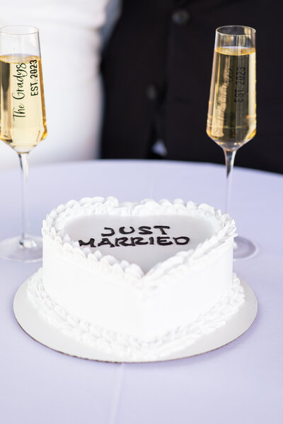 An Austin-based wedding photographer captures a stunning image of a decadent wedding cake and elegantly arranged champagne glasses on a beautifully decorated table.
