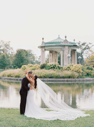 Bride and Groom embrace and kiss in Forest Park