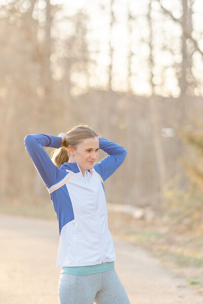 woman fixing her ponytail taken by a Chantilly, VA branding photographer