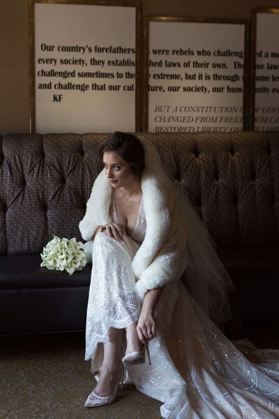 bride looks out the window during her bridal session at Lawless Spirits in Houston Texas by Swish and Click Photography