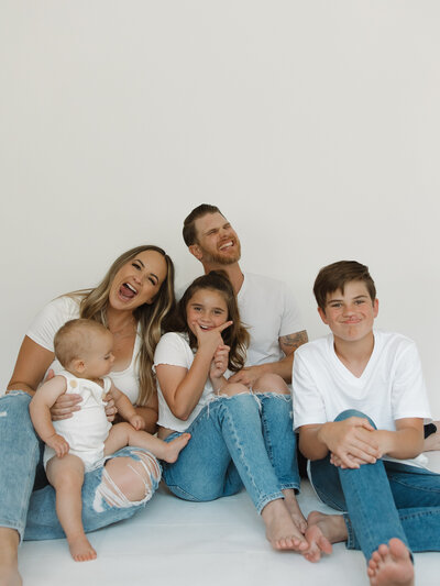 Austin Wedding Photographers Jessie and Dylan Schultz posing with their family  in a studio being silly